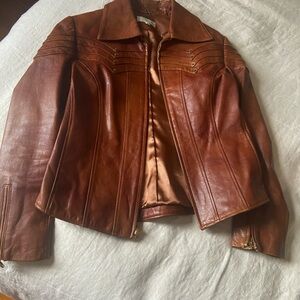 Unique details Jen Lopez leather Jacket still has that new leather feel.